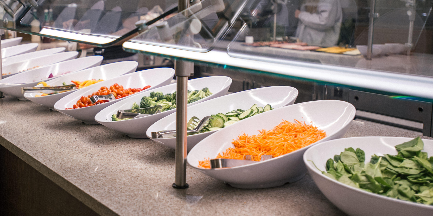 Photo of a salad bar at the Lodge using vegetables from the UCCS Farm.