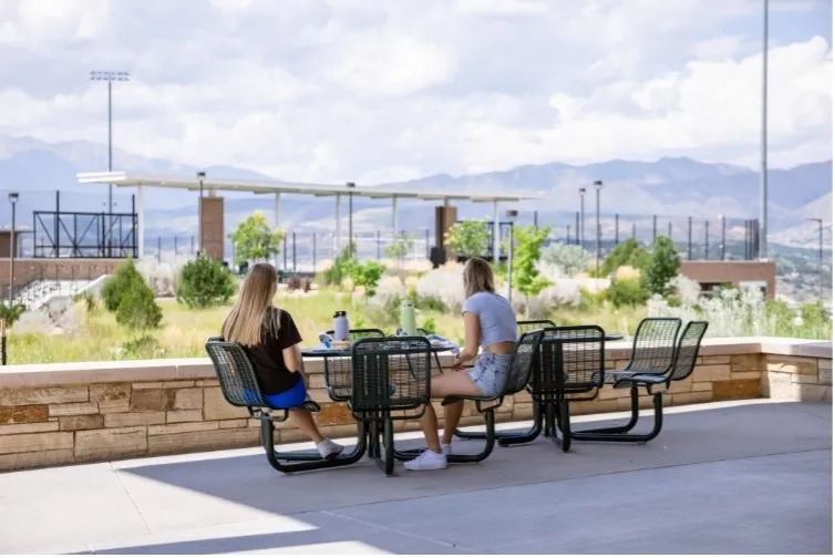 students sitting at tables outside the Roaring Fork dining hall